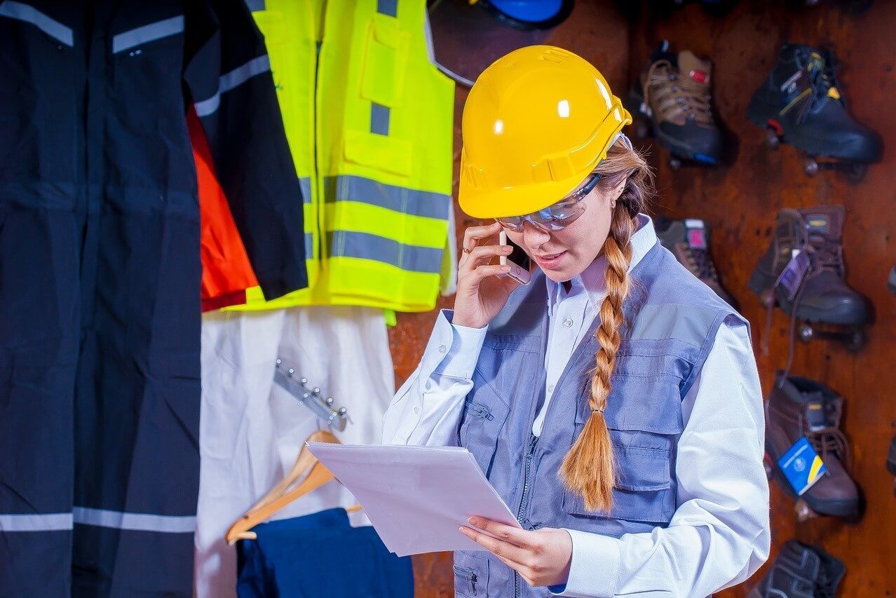 Worker wearing hard hat and talking on mobile phone