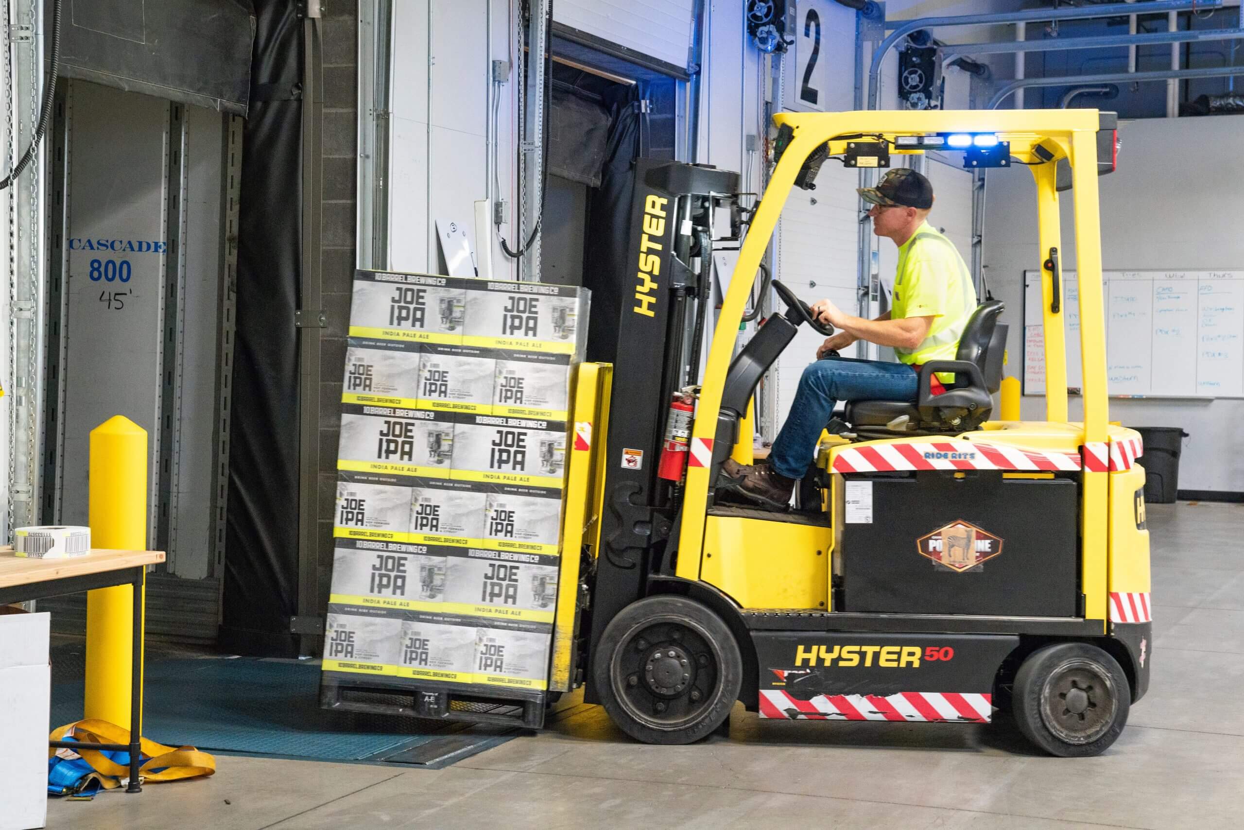 Lone worker moving boxes on forklift