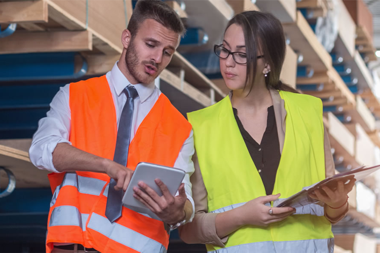 One male and one female worker, both in high-visibility jackets